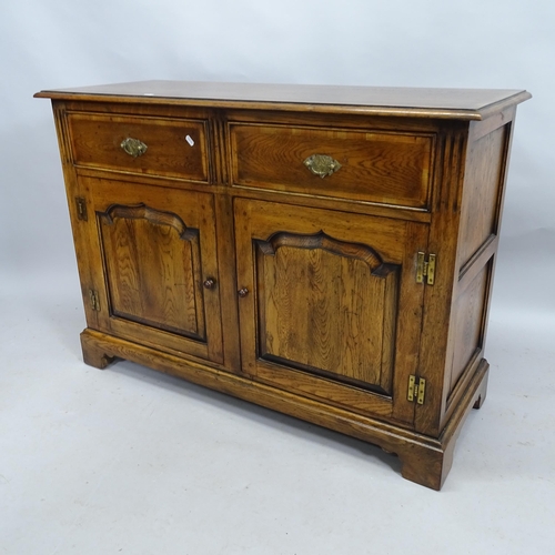 2160 - An Ipswich oak design sideboard with two fitted drawers and cupboards under. 118cm x 85cm x 45cm