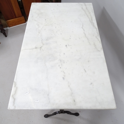 2174 - A marble top garden table on cast iron frame. 100cm x 74cm x 62cm