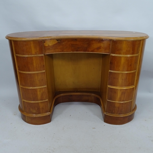 2182 - A mid-century design yew-wood kidney shaped kneehole writing desk with eleven fitted drawers. 123cm ... 