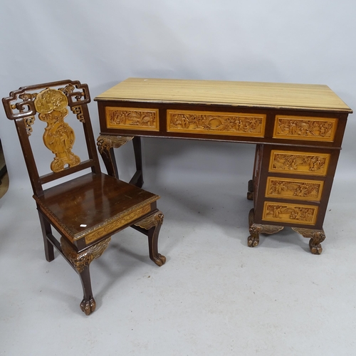 2187 - A modern Chinese camphor wood single pedestal writing desk with 5 fitted drawers and all over carved... 