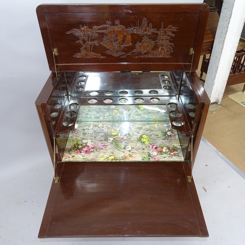 2194 - A Chinese camphorwood cocktail cabinet, the lifting top and fall front revealing a mirrored and fitt... 