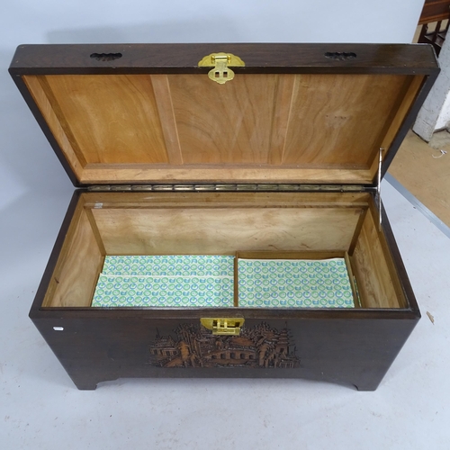 2195 - A Chinese camphorwood blanket box with carved decoration.  102cm x 56cm x 50cm