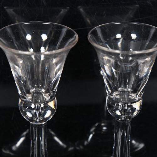 105 - A similar pair of Georgian wine glasses, with bell-shaped bowls on teardrop stems and concave folded... 