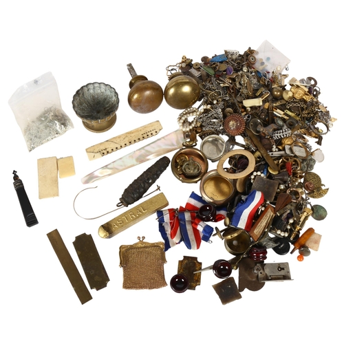 132 - A collection of interesting items, to include military buttons, badge, ribbons, mother-of-pearl, doo... 