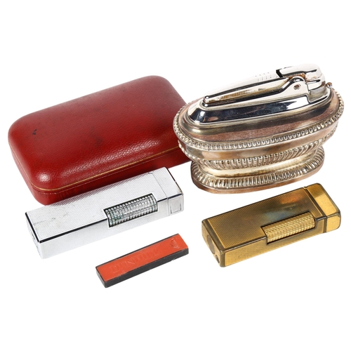 138 - A Vintage Dunhill gold plated lighter in original case, a Ronson silver plated table lighter, and a ... 