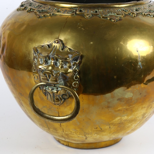 14 - A large Chinese brass jardiniere, with applied engraved and pierced collar with lion mask ring handl... 