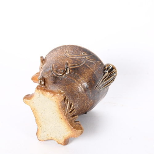 140 - An unusual glazed stoneware eggcup on stand, in the form of a chicken, H5.5cm