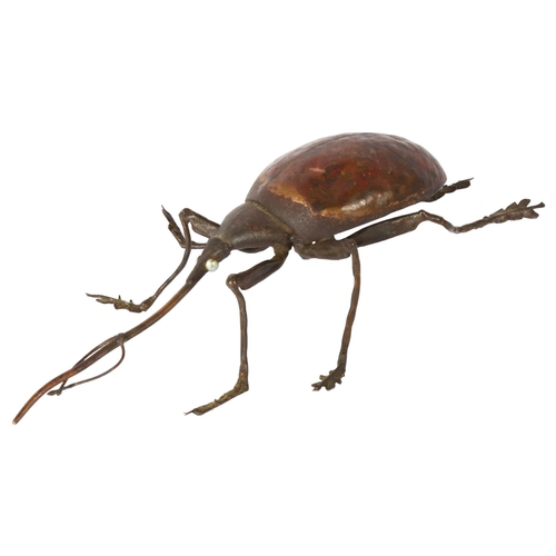 142 - SUE WHITE OAKES - a hammered copper study of a beetle, signed and dated 1985 to the underside, L26cm