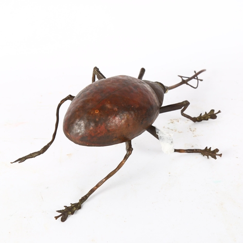 142 - SUE WHITE OAKES - a hammered copper study of a beetle, signed and dated 1985 to the underside, L26cm