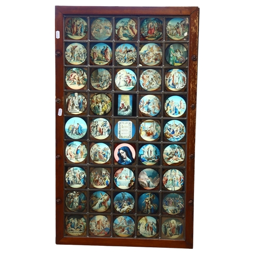 16 - A late 20th century lightbox, the leadlight glass panel depicting 45 religious scenes, the central o... 