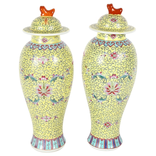 177 - A pair of Chinese famille jaune baluster vases and covers, floral enamel decoration, H32cm