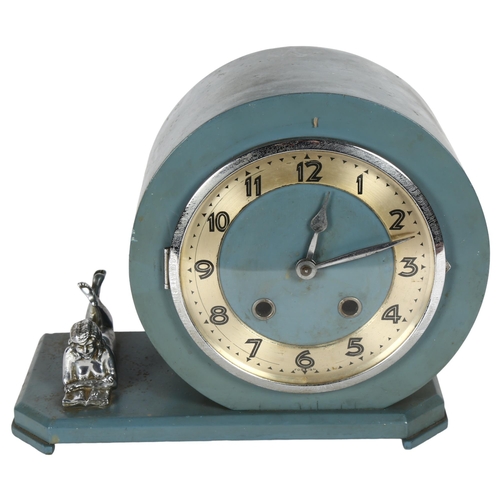 185 - An early 20th century painted mantel clock, with 8-day movement, shaped canted base with figure read... 