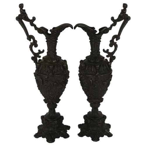 194 - A pair of Renaissance style cast-bronze ewers, ornately decorated with Bacchanalian scenes, with che... 