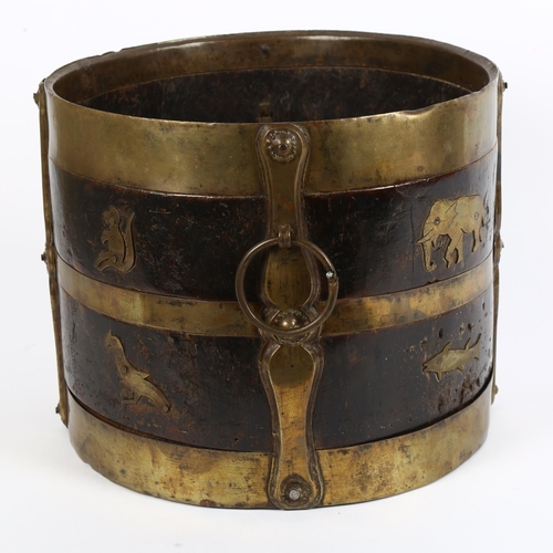 2 - A 19th century Indian wood and brass-bound bucket with ring handles, stylised strapwork and animal d... 