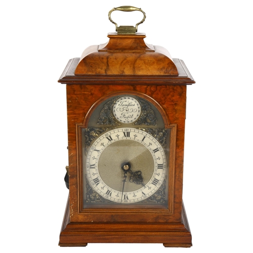 221 - An electric or battery operated walnut-cased mantel clock, H30cm