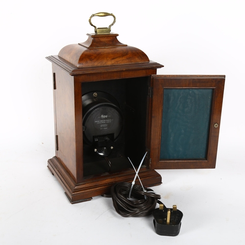 221 - An electric or battery operated walnut-cased mantel clock, H30cm