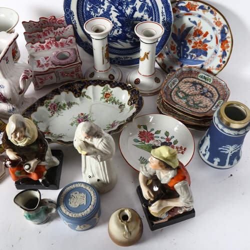 306 - An 18th century Staffordshire figurine depicting a cobbler, and another depicting a lady pouring a d... 