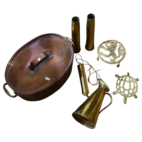 317 - A Victorian copper fish kettle, 2 brass shell casings marked 1944, a brass pot stand with lion decor... 