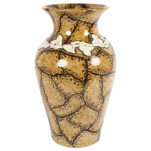 7 - A large brown glazed stoneware vase, with applied white flower garland, H41cm