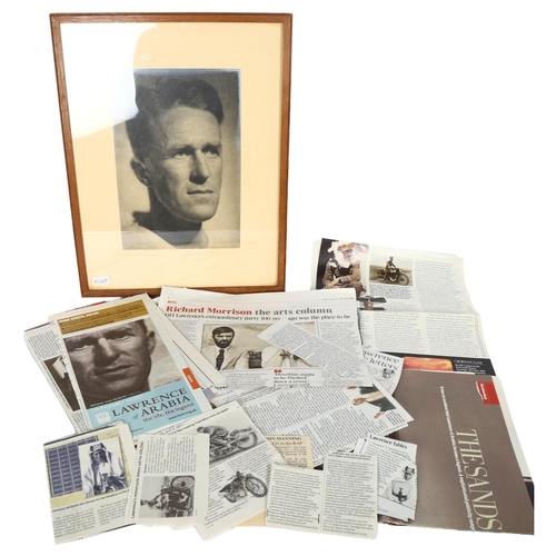 77 - A framed photographic portrait of T E Lawrence, together with a quantity of newspaper cuttings relat... 