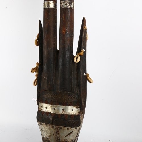 85 - An African hardwood mask, with pressed metal and shell decoration, L90cm