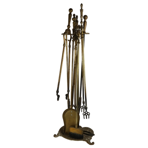 87 - A brass fire companion set