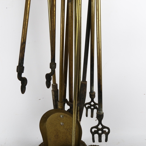 87 - A brass fire companion set