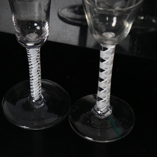 92 - 2 Georgian cordial glasses, both having multiple milk twist spiral columns stems, H15.5cm