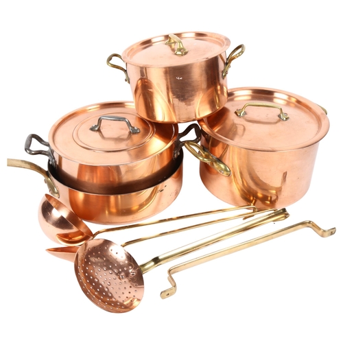 363 - A graduated pair of copper pans with brass handles, largest 30cm overall, 3 copper and brass utensil... 