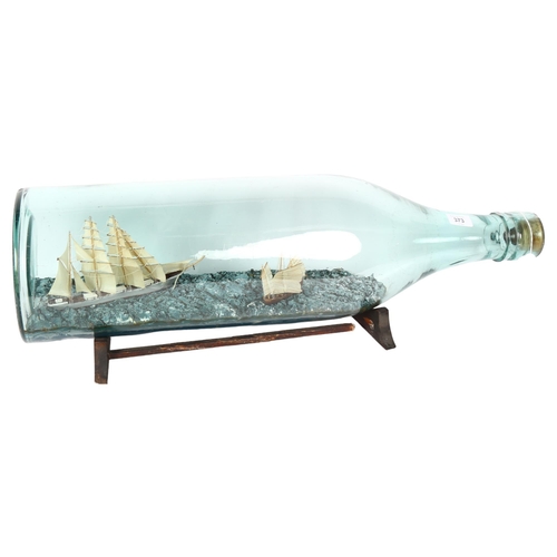 373 - A mid-century scratch-built 4-mastered tea clipper and Chinese junk presented in a tolly bottle, by ... 