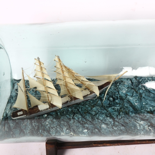 373 - A mid-century scratch-built 4-mastered tea clipper and Chinese junk presented in a tolly bottle, by ... 