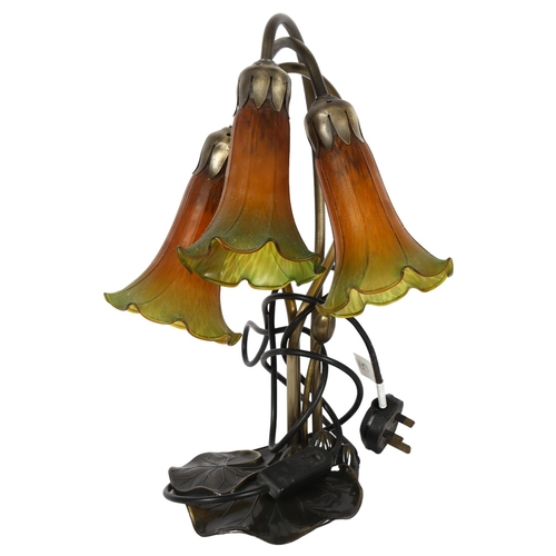 393 - A Tiffany style 3-branch table lamp, with flower-head design shades, H40cm