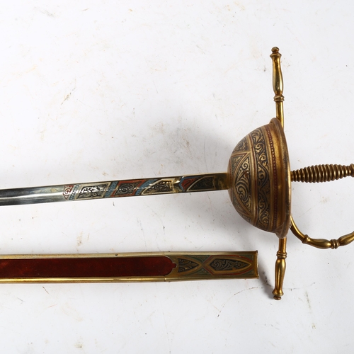 414 - A reproduction decorative sword in scabbard, length overall 66cm