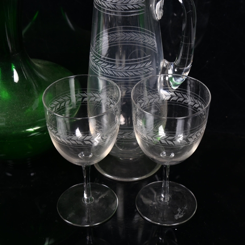 429 - A Whitefriars green glass jug, 27cm, another, an engraved glass jug and 2 matching goblets