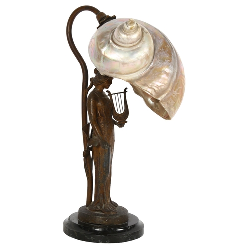 452 - A table lamp with brass figure support, on marble plinth, with seashell shade, H32cm