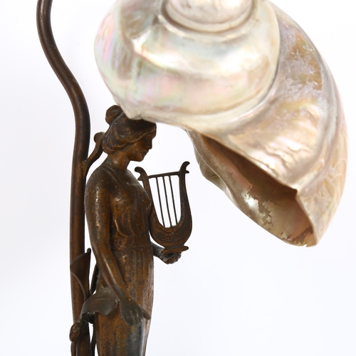 452 - A table lamp with brass figure support, on marble plinth, with seashell shade, H32cm