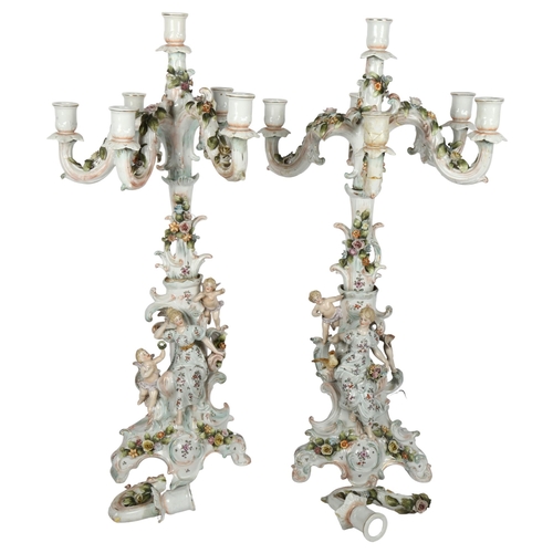 493 - A pair of Antique German 6-branch table candelabras, encrusted with painted flowers, figures and che... 