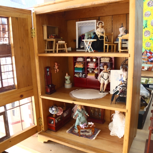 521 - A handmade wooden doll's house, including various dolls and accessories, H69cm, L44cm, D30cm