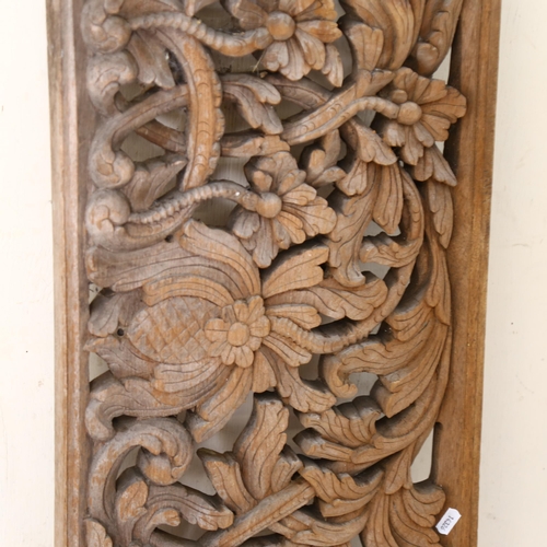 529 - A large Balinese style wood carving, with tropical foliage and fruit decoration, L185cm