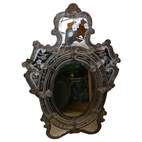 546 - A Venetian wall mirror with elaborate moulded flowerhead mounts and etched panels, overall height 11... 