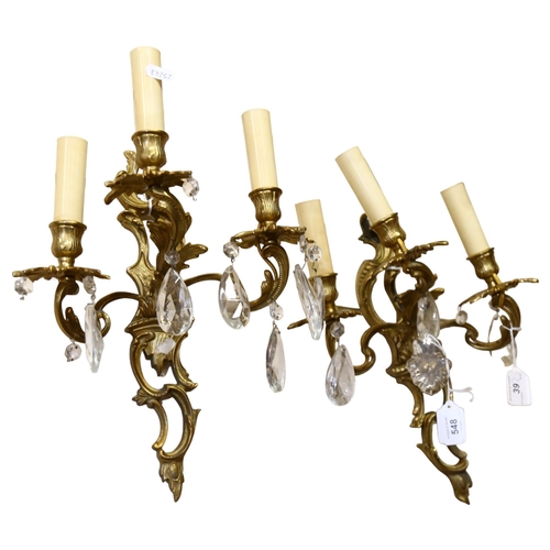 548 - A pair of gilded brass 3-branch wall sconces with glass lustre drops, drop 36cm