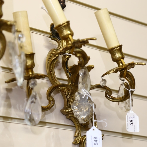 548 - A pair of gilded brass 3-branch wall sconces with glass lustre drops, drop 36cm