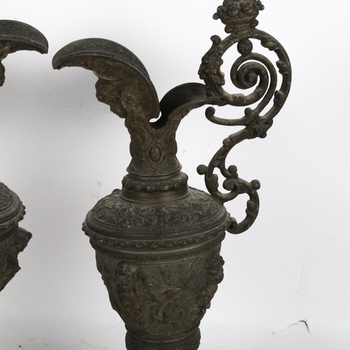 502 - A pair of Italian cast gilt-metal ewers with relief decoration, including cherubs and various floral... 