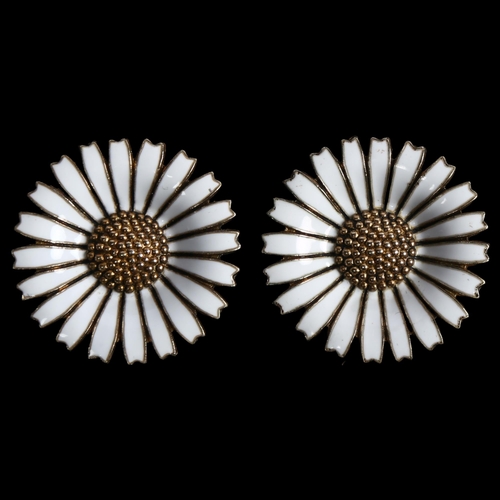 866 - ANTON MICHELSEN - a pair of Danish sterling silver and white enamel daisy pattern clip-on earrings