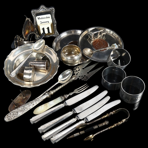 875 - A group of silver items, to include napkin rings, small circular dish, silver-handled knives etc, 7.... 