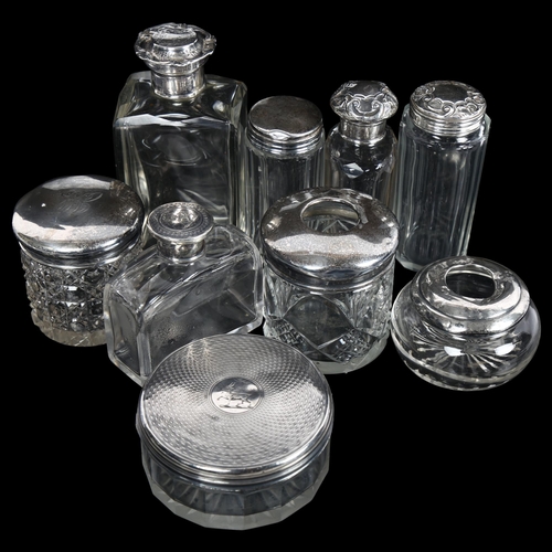 878 - A group of various silver-topped dressing table jars, powder bowls, hair tidies etc (9)