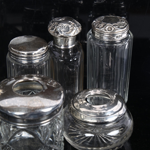 878 - A group of various silver-topped dressing table jars, powder bowls, hair tidies etc (9)