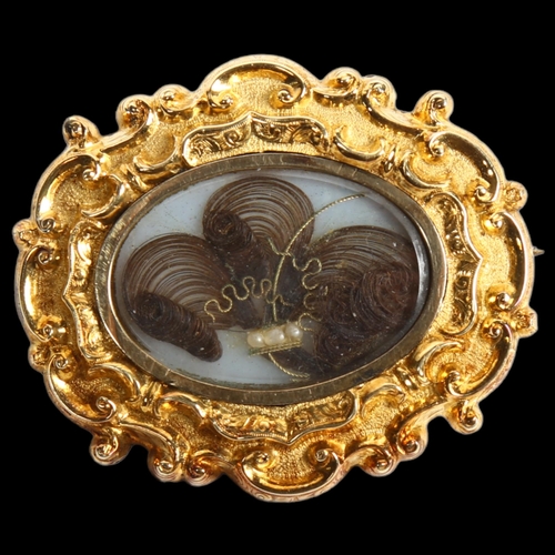 908 - An ornate Victorian pinchbeck mourning brooch with hair panel