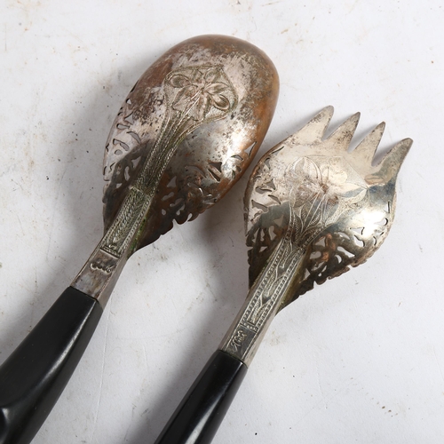 822 - A pair of Middle Eastern white metal servers, with pierced and engraved bowls