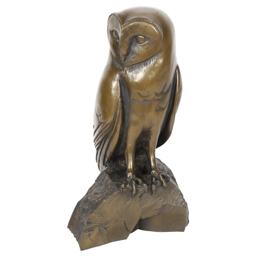 670 - A resin bronze study of an owl on a rock, impressed M to the reverse, H28cm